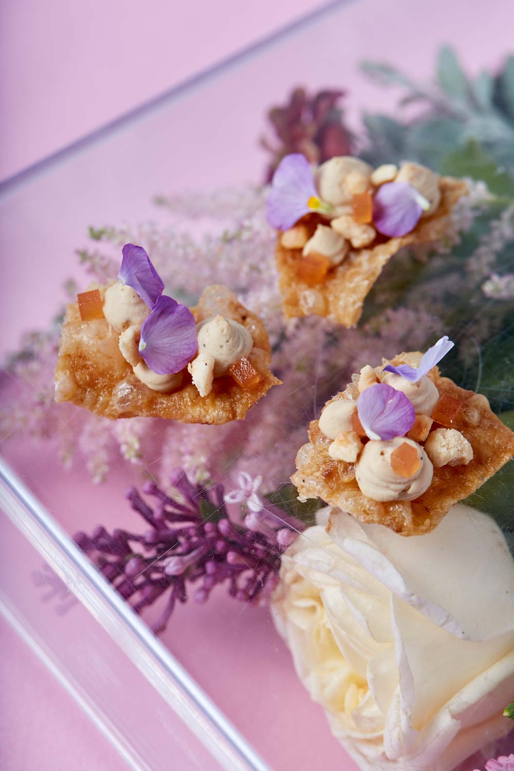 Savoury treats decorated with edible flower petals