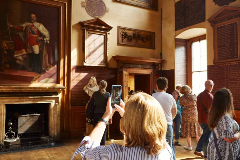 A group of visitors explore the Great Hall at the end of a Sunday lunchtime tour of Barts North Wing