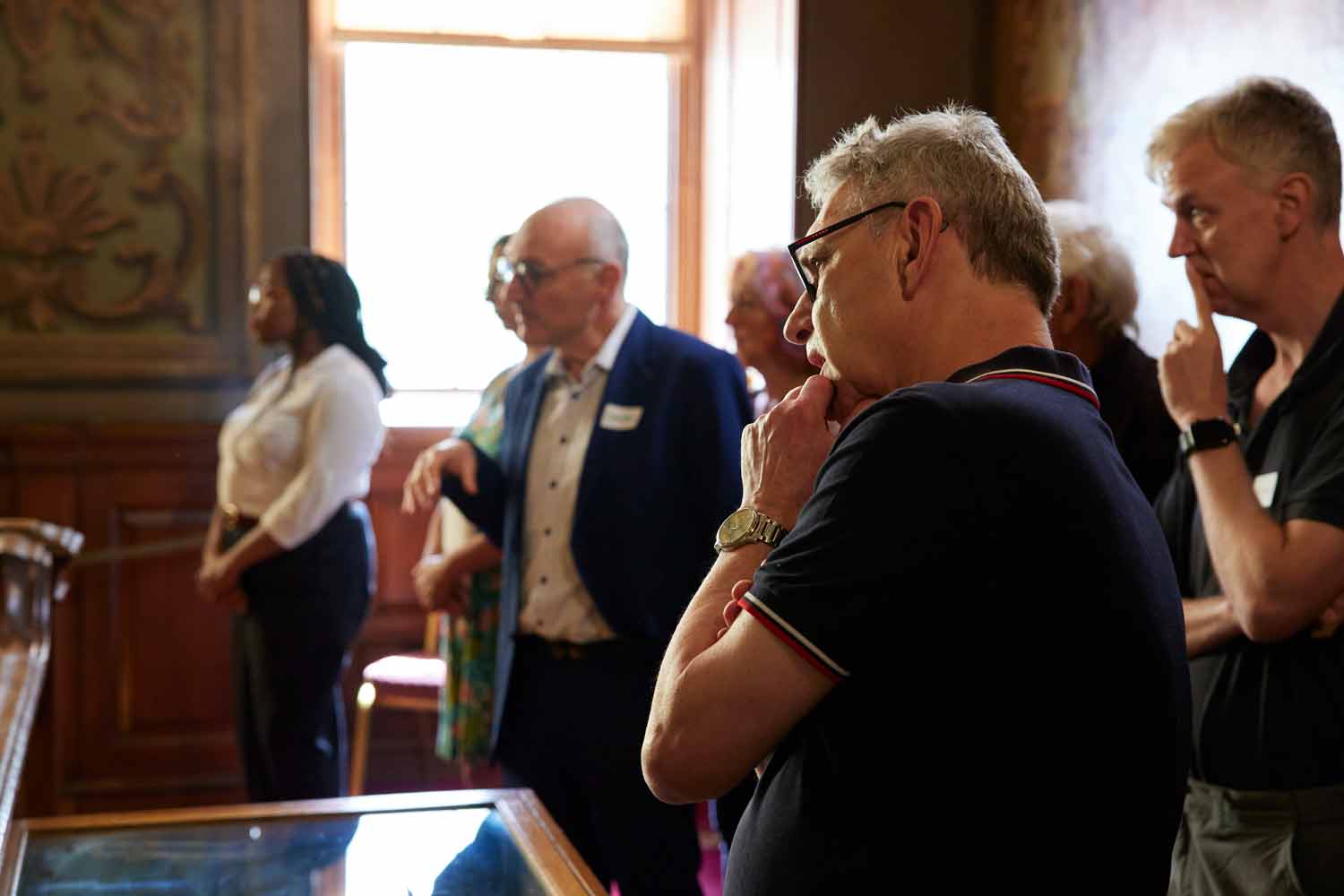 A group of visitors on a tour of Barts North Wing visit the Hogarth Stair
