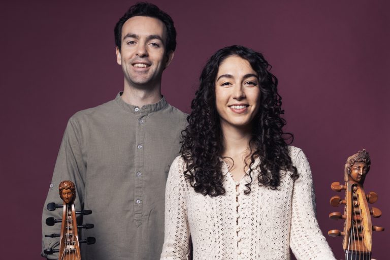 Man and woman each holding a gamba.
