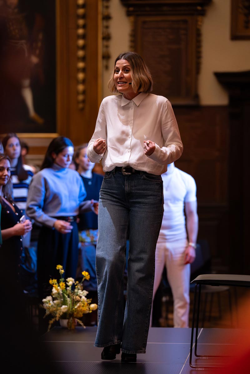 Presenter on stage at the Zoe event